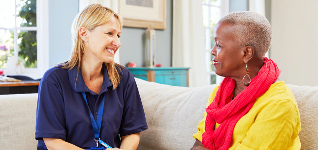 caregiver and senior woman having a conversation