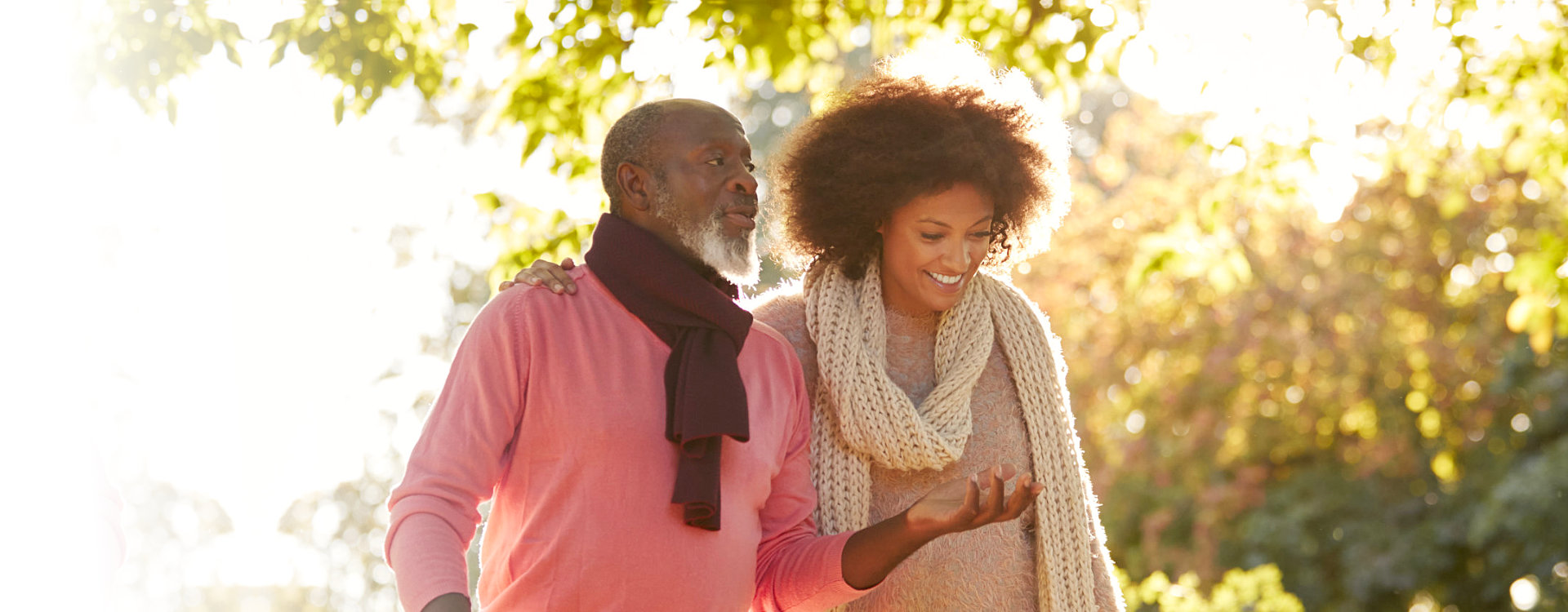 caregiver and senior woman having a conversation while walking