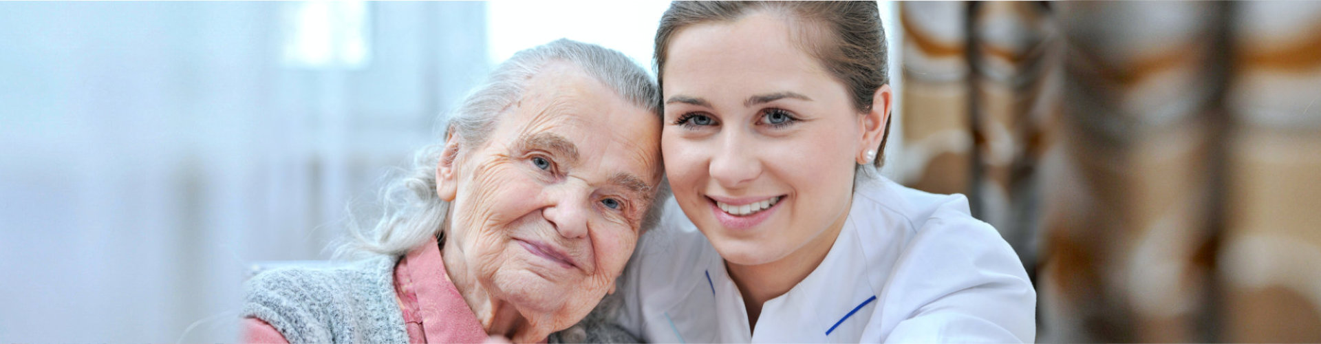 caregiver and senior woman are smiling