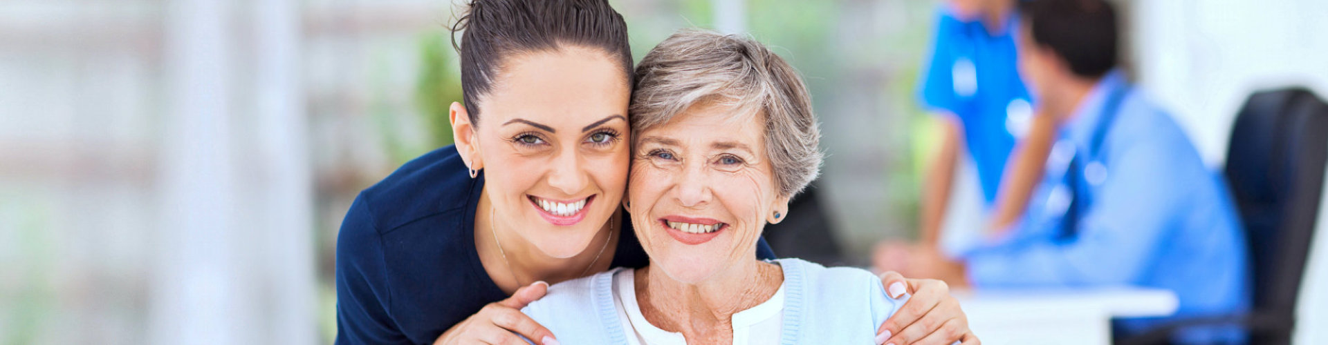 nurse and senior woman are smiling